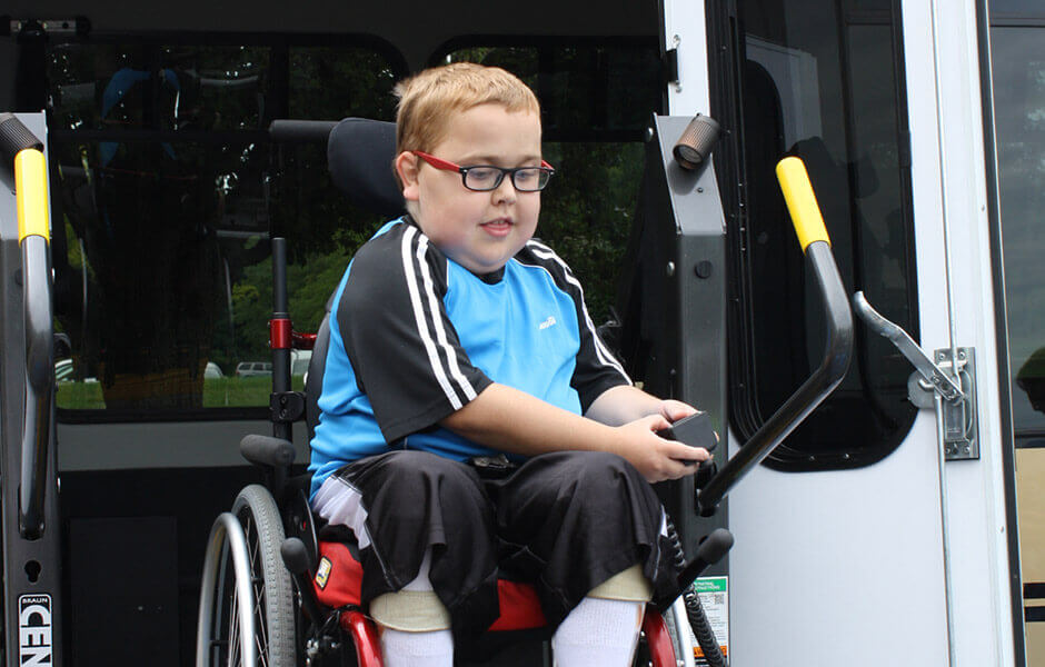 child in wheelchair exiting accessible van