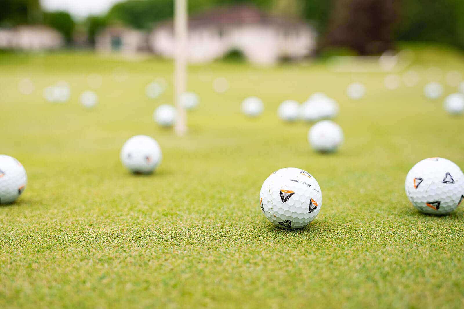 Golf balls scattered on green